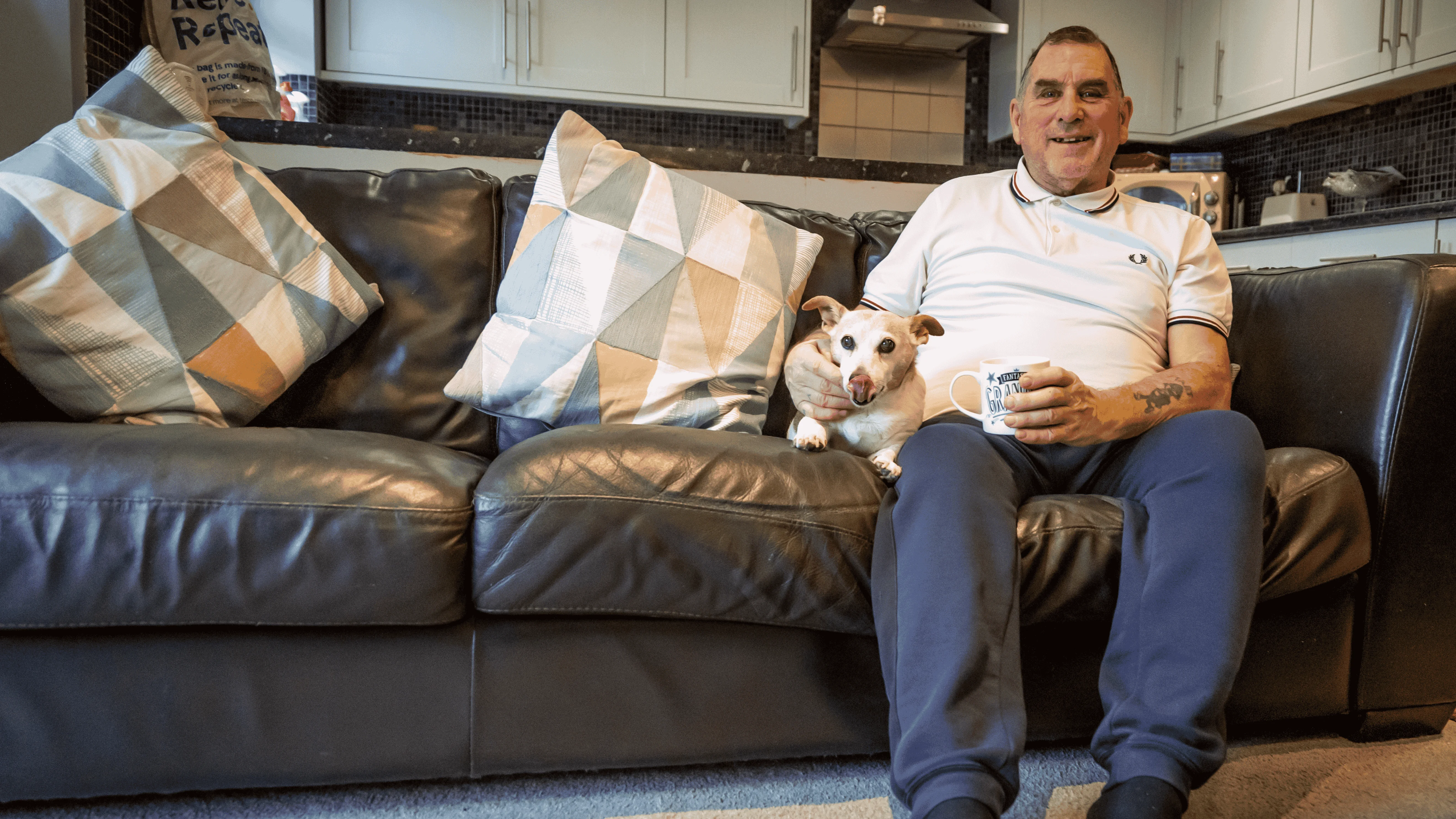 man and dog on couch